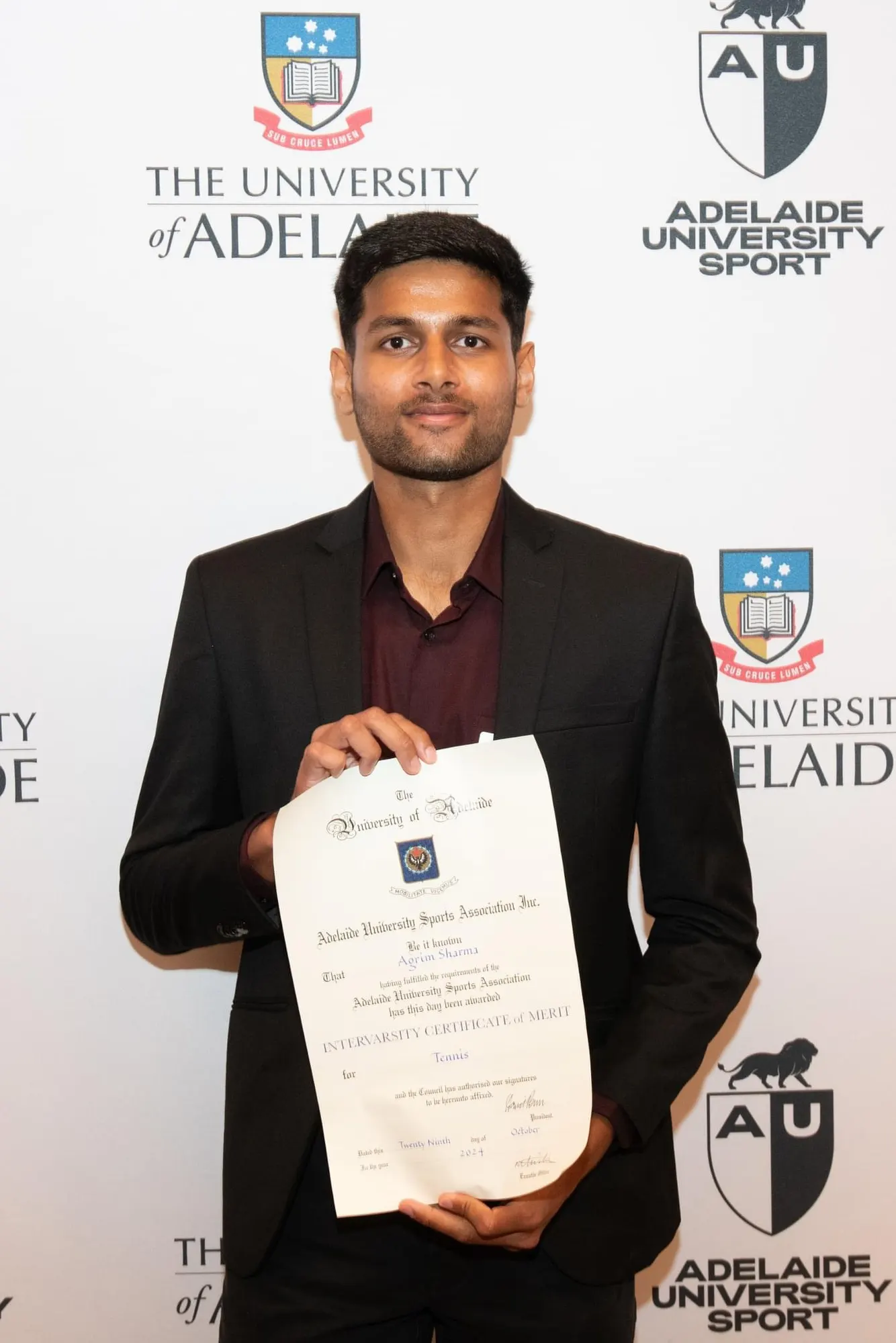 Agrim holding his certificate of merit at the Blues awards